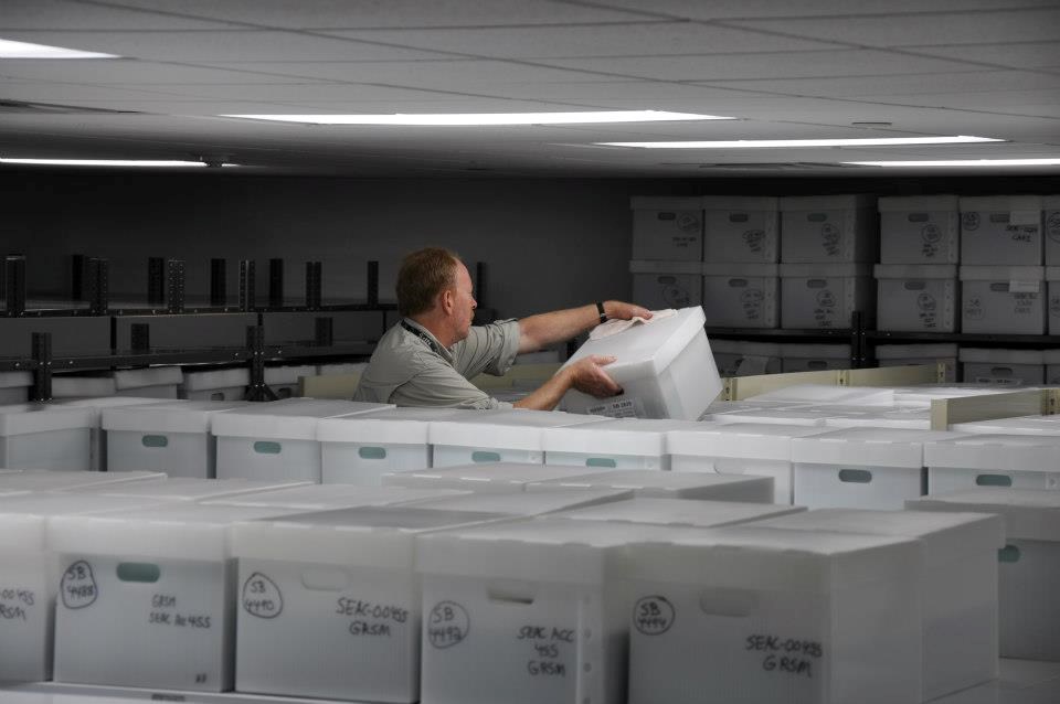 Museum Specialist Hank Kratt organizes boxes in the ACIM storage