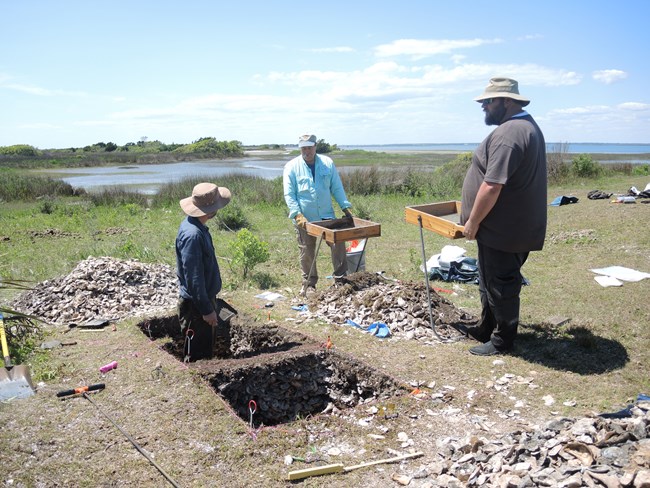 SEAC archeologists excavating at a shell midden site