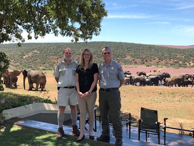 The superintendent of Lake Roosevelt NRA stands with Addo Elephant park employees.