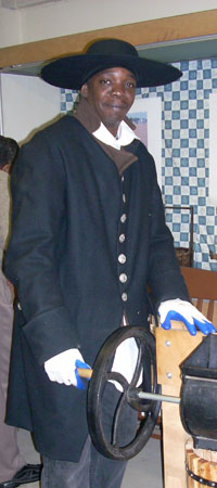 reenactor pressing apple cider