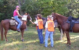 Volunteers talking to horse riders