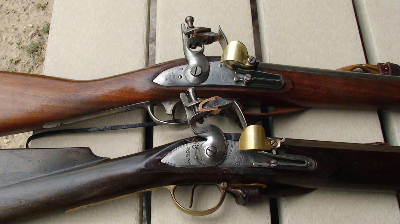 Close up view of two flintlock muskets
