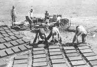 Vintage photo, several men working at adobe brick making