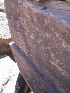 variety of petroglyphs carved into flat rock face variety of petroglyphs carved into flat rock face