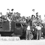 group of Civilian Conservation Corps boys waving at the camera