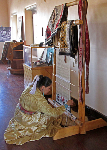 Angeline weaving at Painted Desert Inn