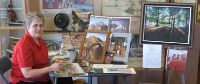 Simper surrounded by some of her artwork