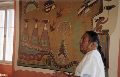 Kabotie in front of colorful mural
