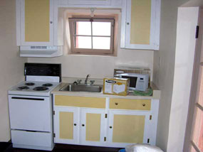 yellow and white painted kitchen