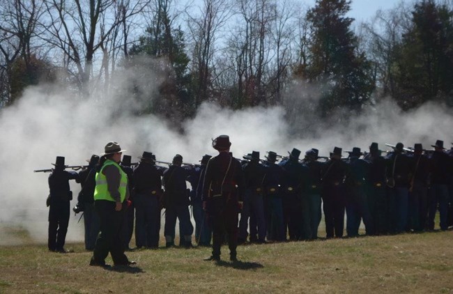 Regiment of soldiers firing muskets