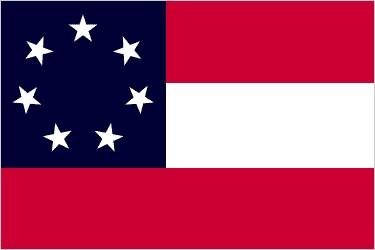Image of a flag, with one large dark blue square with seven white stars inside the box. Opposite the blue square are three large stripes, red, white, and red.