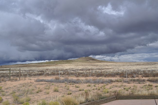 The volcanoes of the West Mesa with a cloudy backdrop.