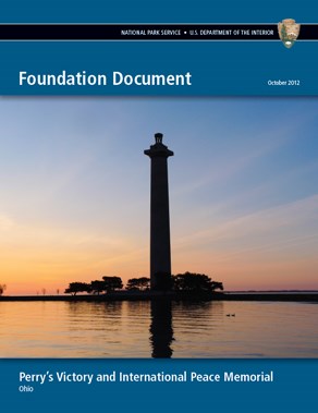 Cover of the Perry's Victory and International Peace Memorial's Foundation Document. Contains a picture of sunrise behind a tall memorial column with water in the foreground.