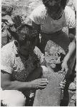 Quarriers Inspect a Piece of Pipestone