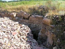 Quarry site showing the quartzite wall and quartzite rubble pile.