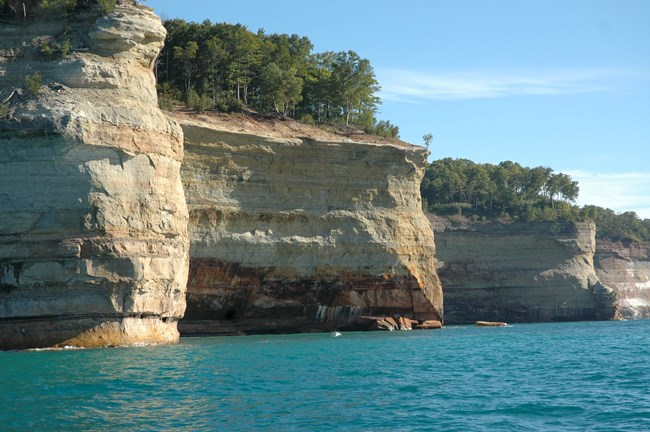 Tall cliffs of Pictured Rocks line up like a row of battleships above Lake Superior.