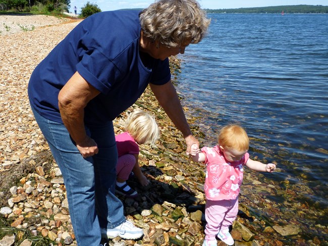 Young toddlers explore lakeshore