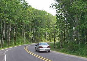 Visitor drives on a recently paved portion of Alger County Road H-58.