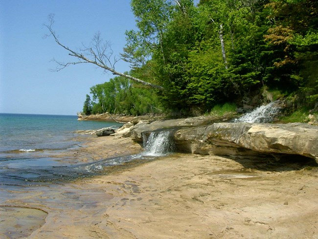 Elliot Falls flowing into Lake Superior at the east end of Miners Beach