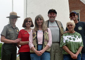The 2008 Au Sable Lighthouse crew pose in front of the light tower.  Volunteers, Park Rangers, and Eastern National staff work together to make the lighthouse open for visitors.