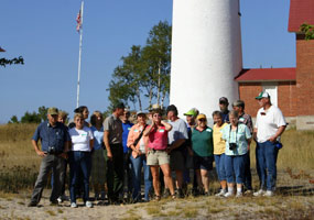 The 2006 participants of the Experience Your Lakeshore program pause for a photo in front of the Au Sable light tower.