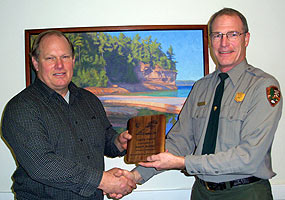 Retiree Brad Bradley receives the Pictured Rocks National Lakeshore Legacy Award from Facility Manager Chris Case.