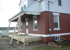 Construction of a new porch on the Grand Marais Harbor of Refuge historic Coast Guard building.