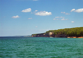 Lake Superior's clear waters appear emerald green on this sunny summer day along the Pictured Rocks.