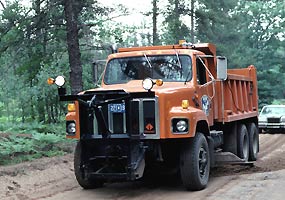 An Alger County Road Commission truck grades County Road H-58. An Alger County Road Commission truck grades County Road H-58.