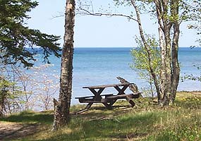 A picnic table near Hurricane River Campground waits patiently for visitors.