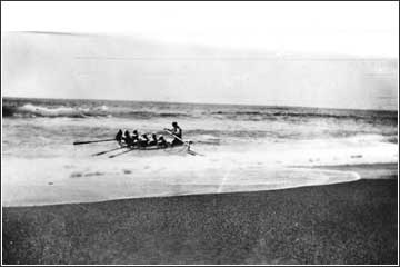 Surfboat & crew heading out through the surf