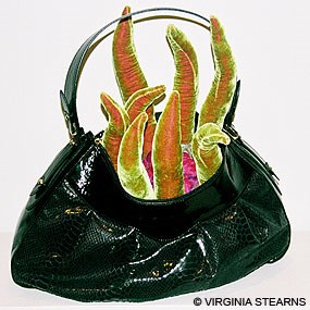 "MOUTH" by Virginia Stearns. [Photo of black purse with orange and yellow tongues protruding from within.]