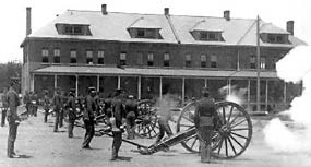 Firing field cannon in front of Infantry Row barracks, circa 1898.
