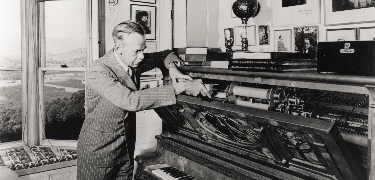 Eugene O'Neill changing the music rolls in his player piano called Rosie in 1941 - Yale Beinecke Library Photo