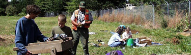 Image of a park archaeologist and staff working an excavation site