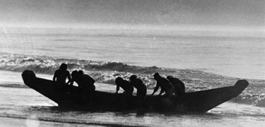 Chumash Indians arriving on shore in a boat near Santa Barbara, California