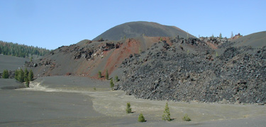 cinder cone with fantastic lava beds and painted dunes in front and clear blue sky above