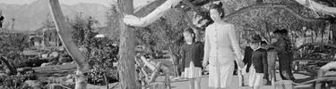 Woman and children enjoy the gazebo and landscaping of Merritt Park. Ansel Adams photo.