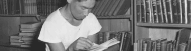 Man reading in Manzanar library. Photo by Dorothea Lange.