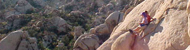 photo of boys climbing on rocks