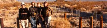 photo of volunteer work group with creosote bush plantings in background