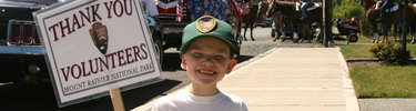 A Junior Ranger volunteer helps with the 4th of July Parade