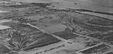 The day after the explosion. Notice the water stranded inland after the explosions tidal wave.