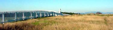 The prairie meets the parade ground fence at American Camp.