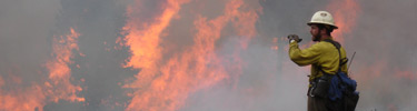 Firefighter in front of intense flames.