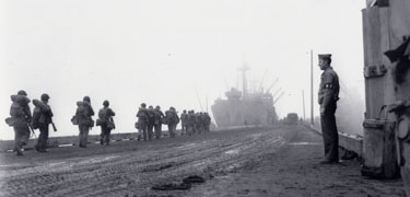 Allied troops file toward their transport vessel, bound for Japanese-held Attu Island in May, 1943.