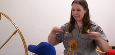 Ranger teaches young visitor to spin