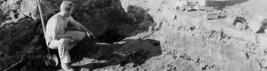 archeologist in deep pit