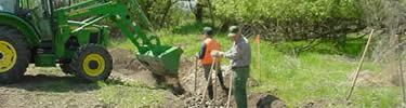 Backhoe digging new streambed