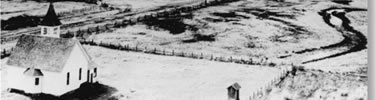 historic photo circa 1900: Whitman-Eells church with outhouse, farmland in background